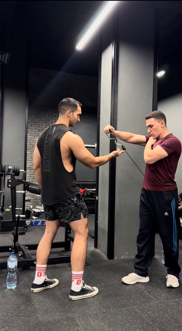 Hima demonstrating a cable exercise to a client