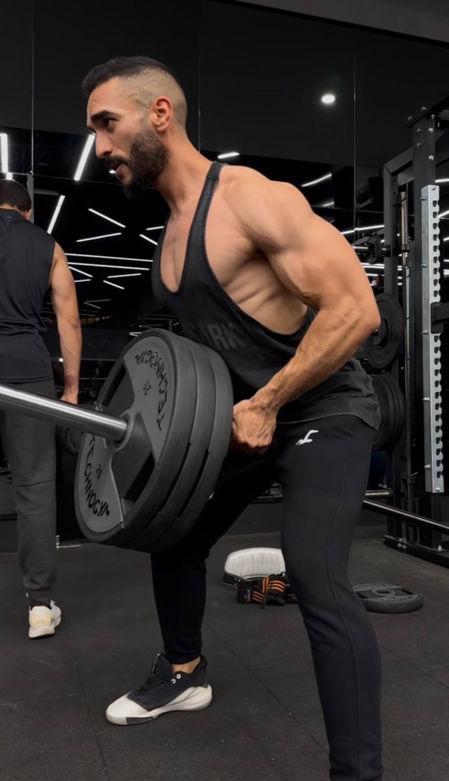 Muhammed training on a plate-loaded row
